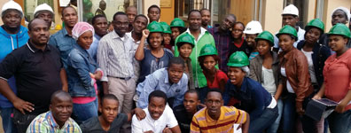 The group pose for a photo before the factory tour.